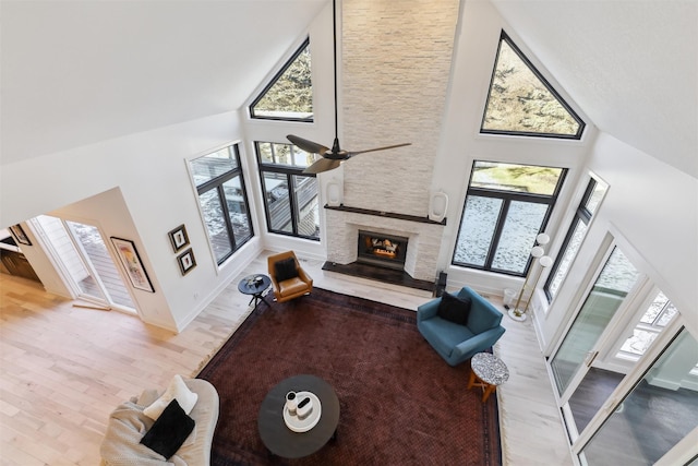 living room featuring a towering ceiling, light hardwood / wood-style flooring, and plenty of natural light