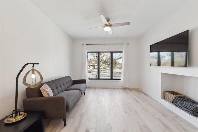 sitting room featuring ceiling fan and light hardwood / wood-style flooring