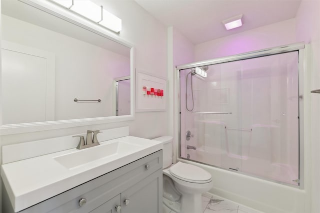 full bathroom with bath / shower combo with glass door, vanity, and toilet