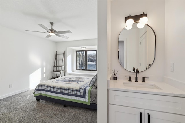 carpeted bedroom with sink and ceiling fan