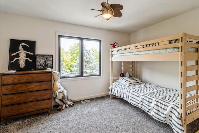 bedroom featuring ceiling fan and carpet