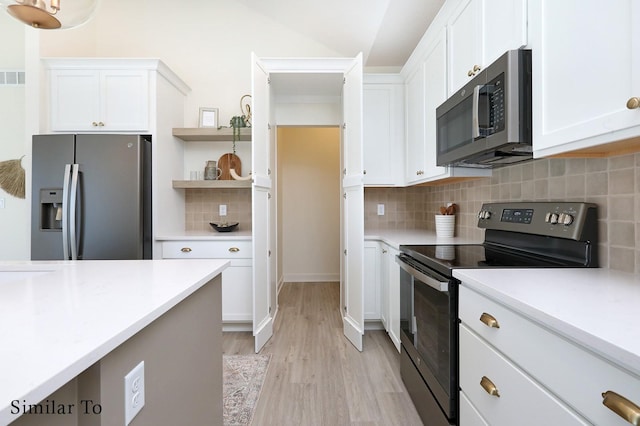 kitchen with white cabinets, decorative backsplash, light hardwood / wood-style flooring, and appliances with stainless steel finishes