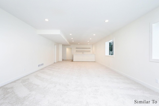 unfurnished living room with light carpet