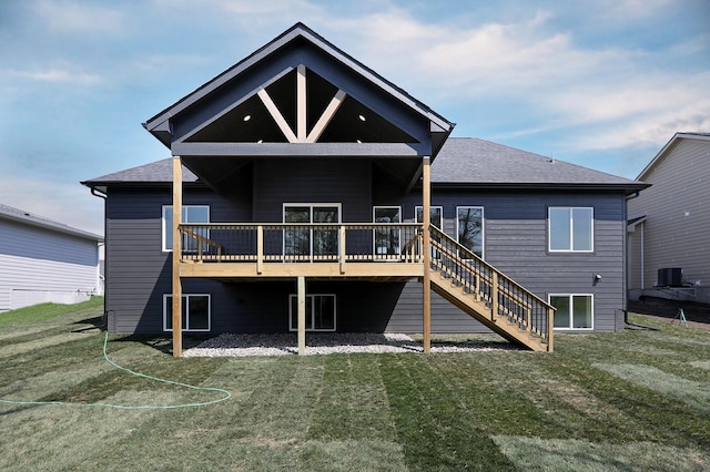 back of house featuring a deck and a yard