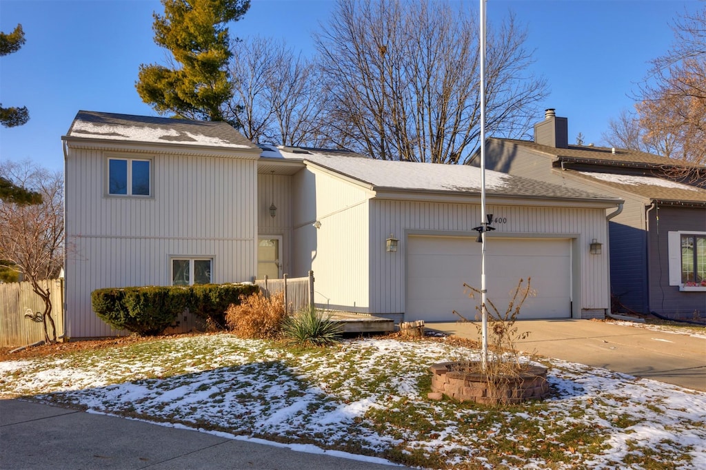 view of snow covered exterior with a garage