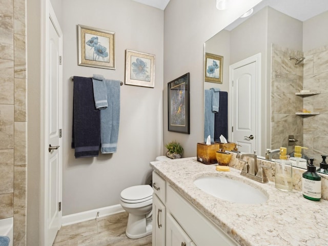 bathroom with toilet, a tile shower, and vanity