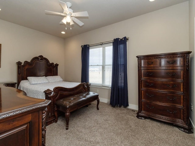 bedroom with ceiling fan and light carpet