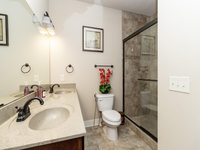 bathroom with walk in shower, vanity, and toilet