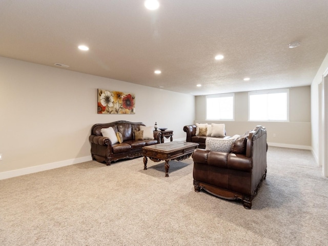 carpeted living room featuring a textured ceiling