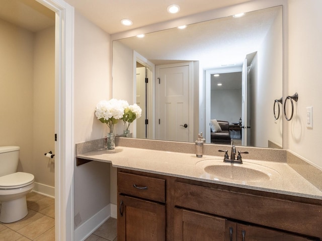 bathroom featuring toilet, vanity, and tile patterned floors