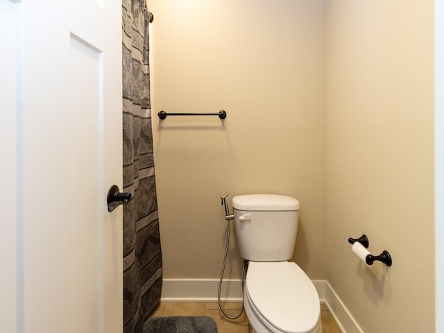 bathroom featuring toilet and tile patterned floors