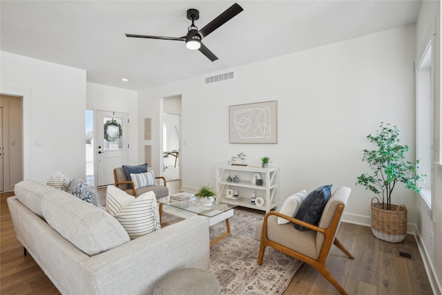 living room with hardwood / wood-style flooring and ceiling fan