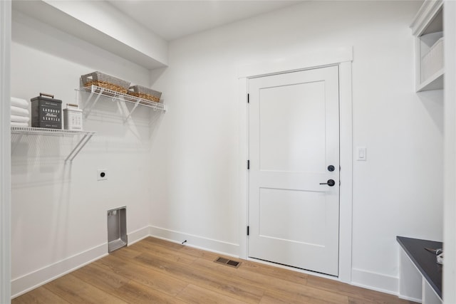 laundry room featuring hookup for an electric dryer and hardwood / wood-style floors