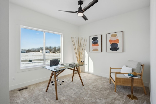 carpeted office space with ceiling fan