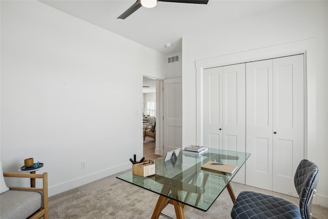 carpeted office with ceiling fan