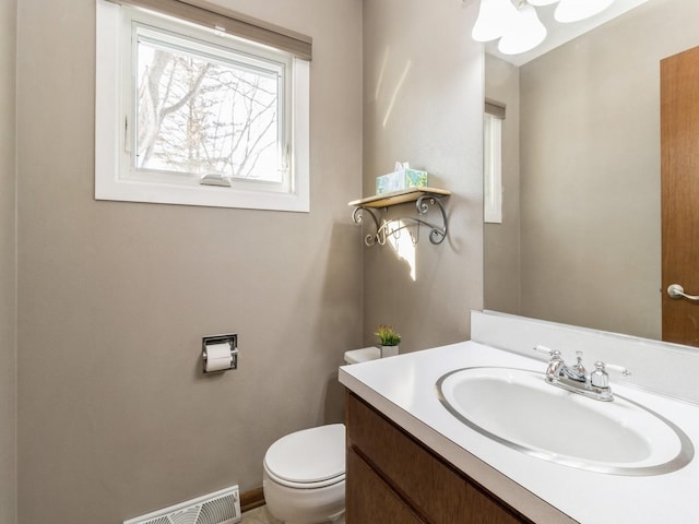 bathroom with toilet and vanity