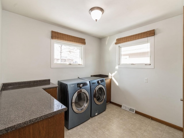 clothes washing area featuring separate washer and dryer