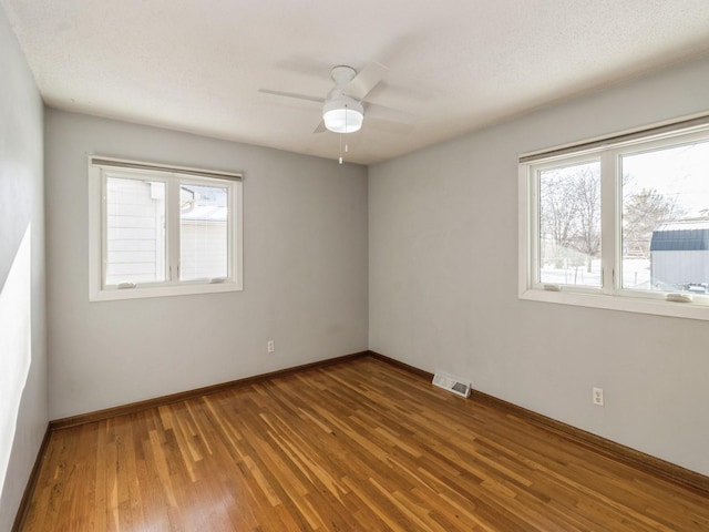 unfurnished room featuring wood-type flooring and ceiling fan