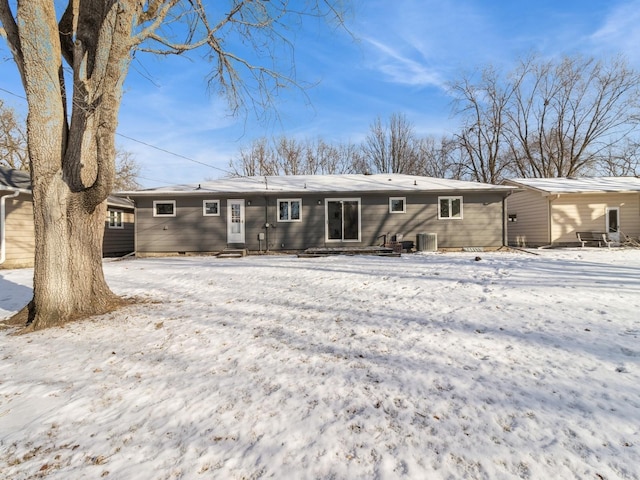 view of snow covered rear of property