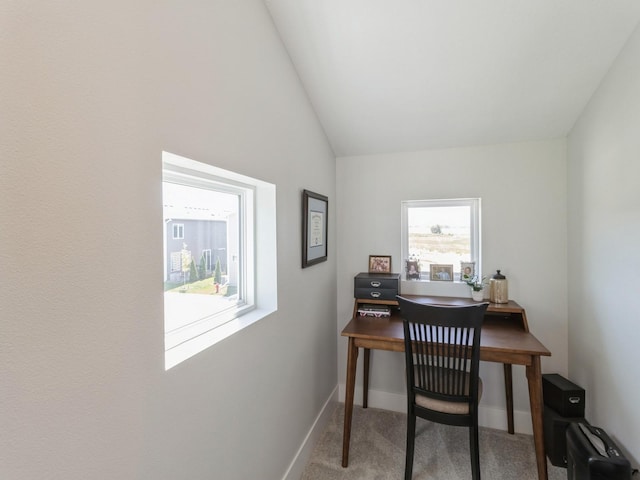 office featuring a wealth of natural light, vaulted ceiling, and carpet