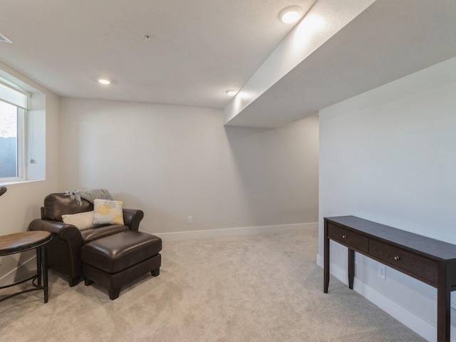 sitting room featuring light colored carpet