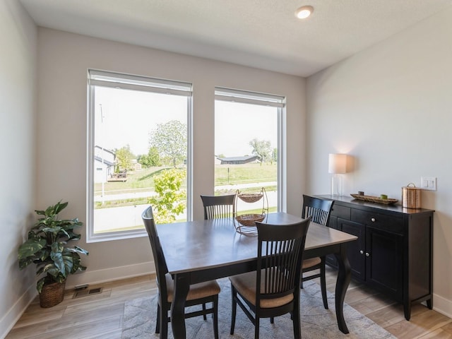 dining space with light hardwood / wood-style flooring