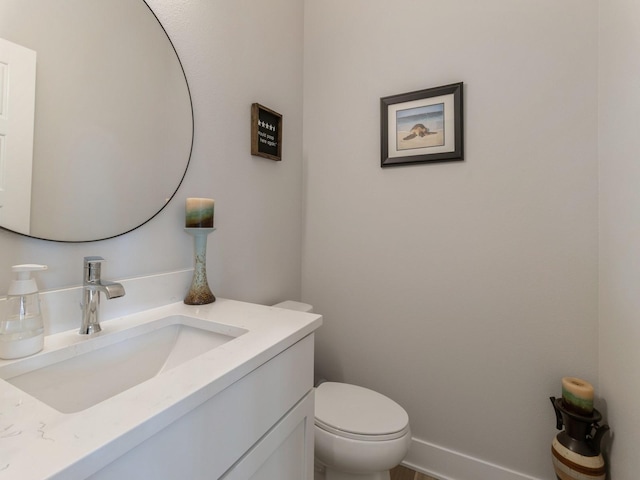 bathroom featuring toilet and vanity