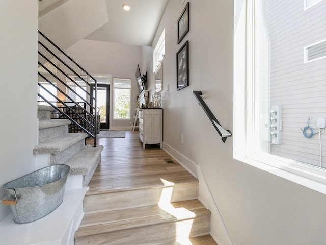 stairway with hardwood / wood-style floors