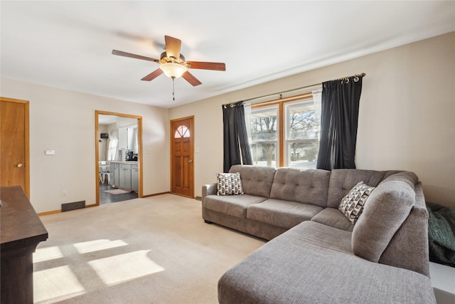 living room with ceiling fan and light colored carpet