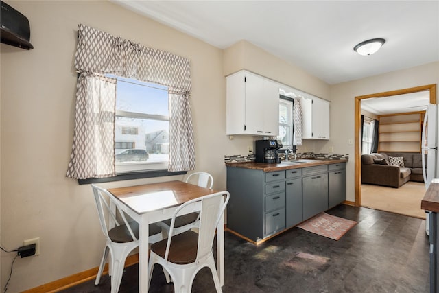 kitchen with gray cabinetry, a healthy amount of sunlight, white cabinetry, and sink