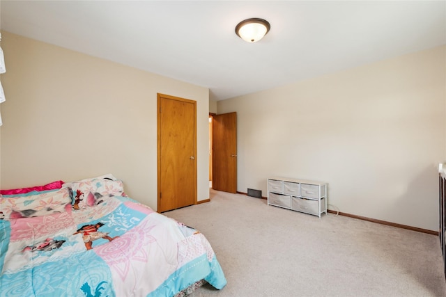 bedroom featuring light colored carpet