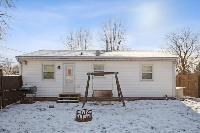 view of snow covered back of property