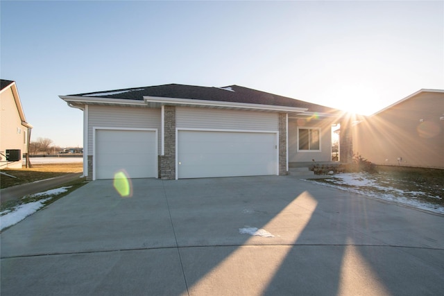 view of front of house with central AC and a garage