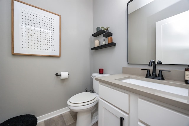 bathroom featuring hardwood / wood-style flooring, vanity, and toilet