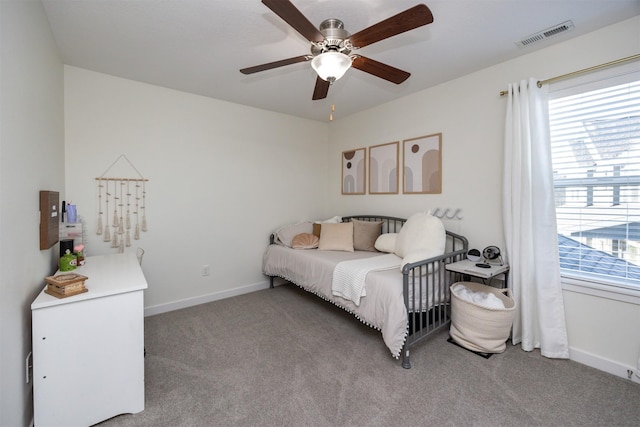 bedroom featuring multiple windows, ceiling fan, and carpet