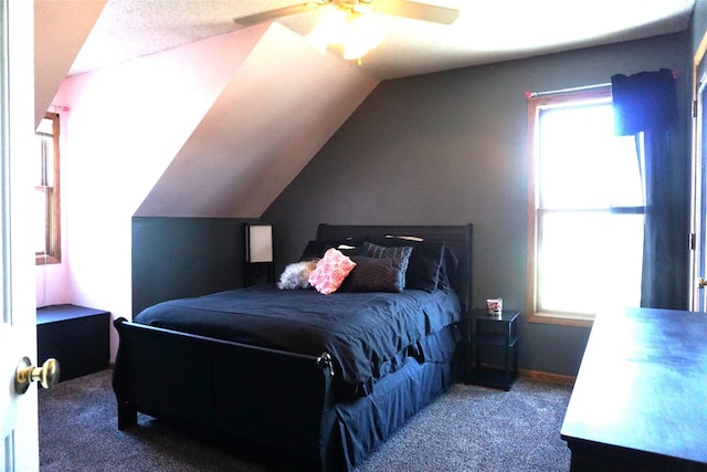 bedroom featuring ceiling fan, multiple windows, carpet, and lofted ceiling