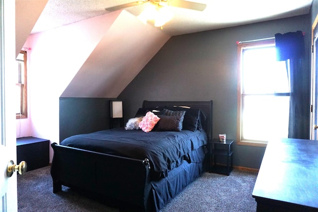 bedroom with ceiling fan, lofted ceiling, and carpet flooring