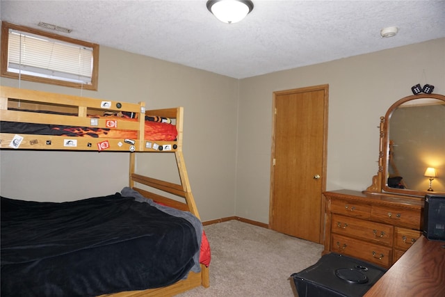 carpeted bedroom with a textured ceiling