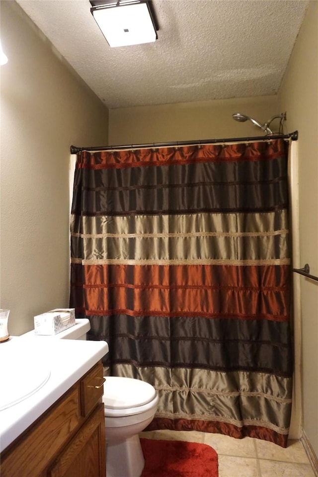 bathroom featuring a textured ceiling, toilet, walk in shower, and vanity