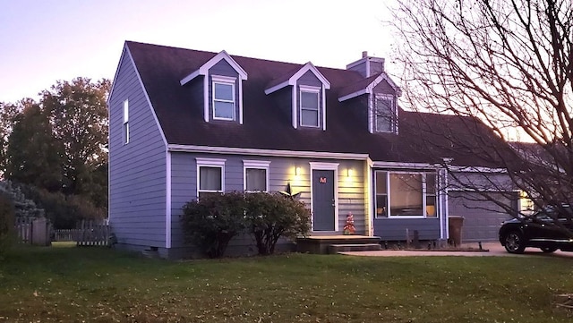 cape cod home featuring a lawn