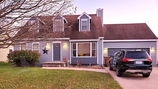 cape cod house with a garage and a lawn