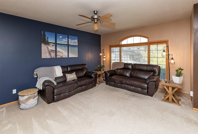 carpeted living room featuring ceiling fan