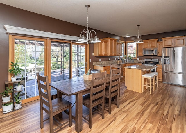 dining room featuring light hardwood / wood-style floors and a notable chandelier