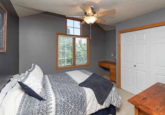 carpeted bedroom featuring ceiling fan and a closet