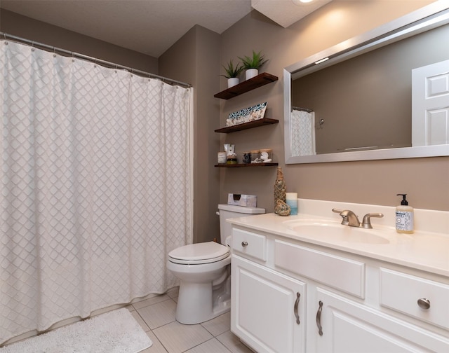 bathroom featuring toilet, vanity, and tile patterned flooring