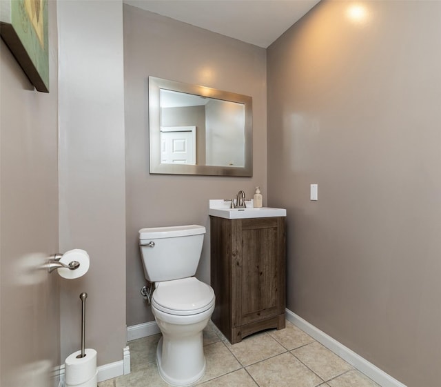 bathroom featuring toilet, vanity, and tile patterned flooring