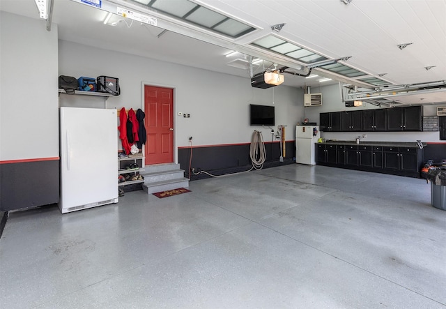 garage with an AC wall unit, a garage door opener, and white fridge