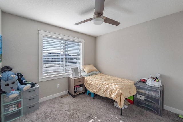 bedroom featuring ceiling fan and carpet