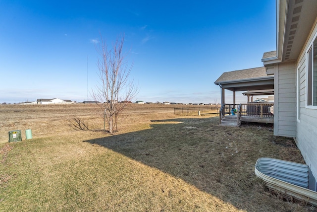 view of yard featuring a deck and a rural view