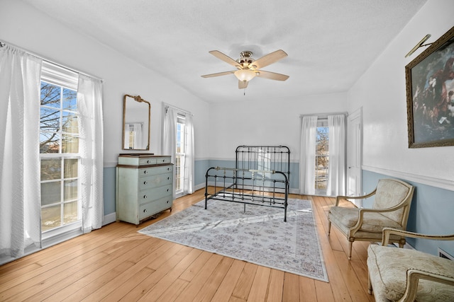 bedroom with light hardwood / wood-style flooring and multiple windows